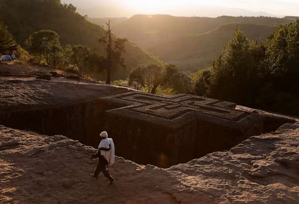 PHOTO: An Ethiopian Orthodox pilgrim walks past the St.George Rock-Hewn church ahead of the Ethiopian Christmas Eve celebration in Lalibela, Ethiopia, Jan. 6, 2023. (Tiksa Negeri/Reuters)