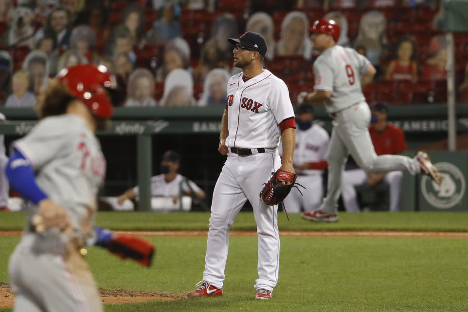 Boston Red Sox relief pitcher Marcus Walden watches the ball after Philadelphia Phillies' Jay Bruce (9) hit a three-run home run during the eighth inning of a baseball game Tuesday, Aug. 18, 2020, at Fenway Park in Boston. (AP Photo/Winslow Townson)