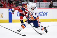 New York Islanders center Casey Cizikas (53) winds up for a shot in front of Washington Capitals defenseman Nick Jensen, back, during the first period of an NHL hockey game, Wednesday, March 29, 2023, in Washington. (AP Photo/Nick Wass)