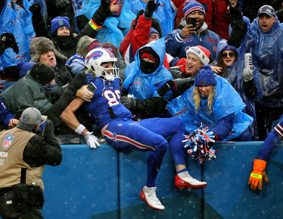 Bills tight end Dawson Knox jumps into the stands to celebrate his touchdown reception just at the end of the first half 