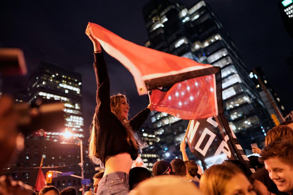 TOPSHOT - Toronto Raptors fans celebrate their win in the NBA championships in downtown Toronto, Ontario on early June 14, 2019. (Photo by Geoff Robins / AFP) (Photo credit should read GEOFF ROBINS/AFP/Getty Images)