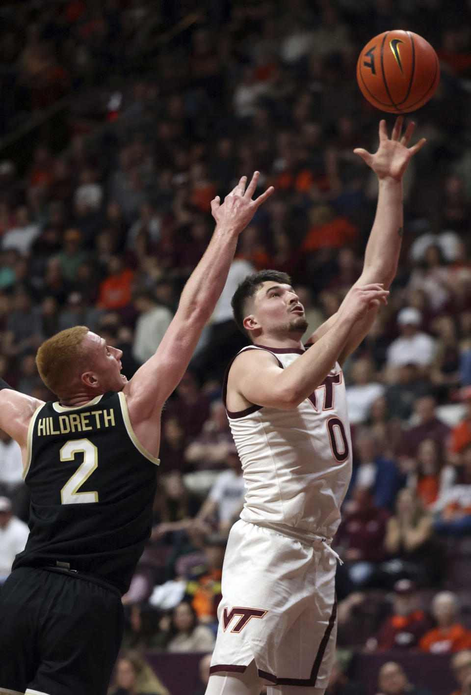 Virginia Tech's Hunter Cattoor (0) scores past Wake Forest's Cameron Hildreth (2) during the first half of an NCAA college basketball game Saturday, March 2, 2024, in Blacksburg, Va. (Matt Gentry/The Roanoke Times via AP)