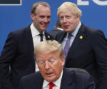 FILE - In this Wednesday, Dec. 4, 2019 file photo U.S. President Donald Trump, center, seated, British Prime Minister Boris Johnson, rear right, and British Foreign Secretary Dominic Raab, rear left, attend a NATO round table meeting at The Grove hotel and resort in Watford, Hertfordshire, England. (AP Photo/Frank Augstein, File)