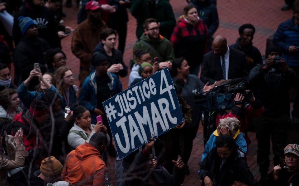 Protestors outside the Hennepin County Courthouse on March 30, 2016 in Minneapolis, after Hennepin County Attorney Mike Freeman announced there would be no charges brought against the officers involved in the death of Jamar Clark in November 2015 - Stephen Maturen/Getty Images North America