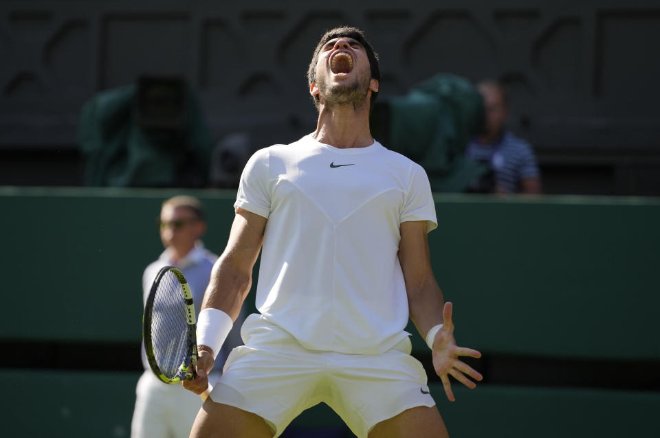 Spain's Carlos Alcaraz celebrates winning the first set against Denmark's Holger Rune in a men's singles match on day ten of the Wimbledon tennis championships in London, Wednesday, July 12, 2023. (AP Photo/Kirsty Wigglesworth)