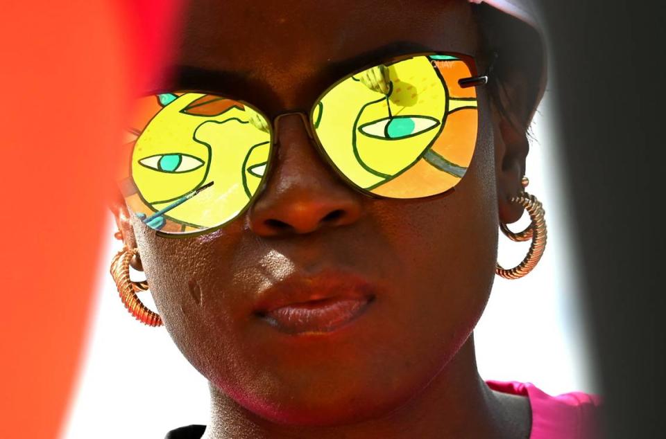 The mural Rays of Sunshine is reflected in the sunglasses of Jo’Nay Prioleau, an employee with Carolina Complete Health on Friday, April 19, 2024. Prioleau and her co-workers joined employees from other local companies for the 19th Charlotte Playground Build at Westerly Hills Academy. The playground build is presented by United Way of Greater Charlotte that brings together companies across the community to build a new playground for a local Charlotte-Mecklenburg elementary school.