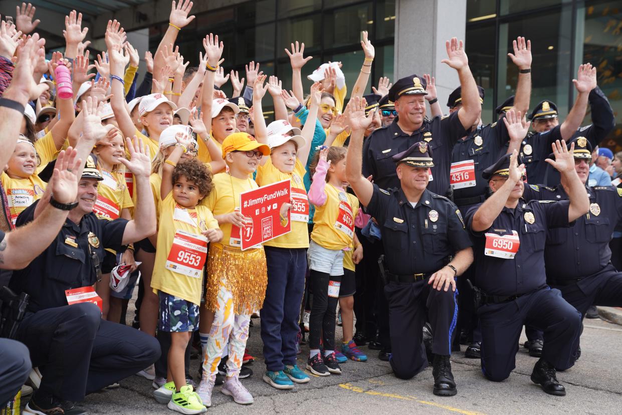 Police and kids at the 2023 Boston Marathon Jimmy Fund Walk in Boston, Oct. 1, show their support to the walkers who have campaigned to raise money for cancer research and treatment at the Dana-Farber Cancer Institute. Walk Director Zachary Blackburn said donations were on pace to break a new record this year, the second in-person walk since the pandemic-forced switch to a virtual walk in 2020 and 2021.