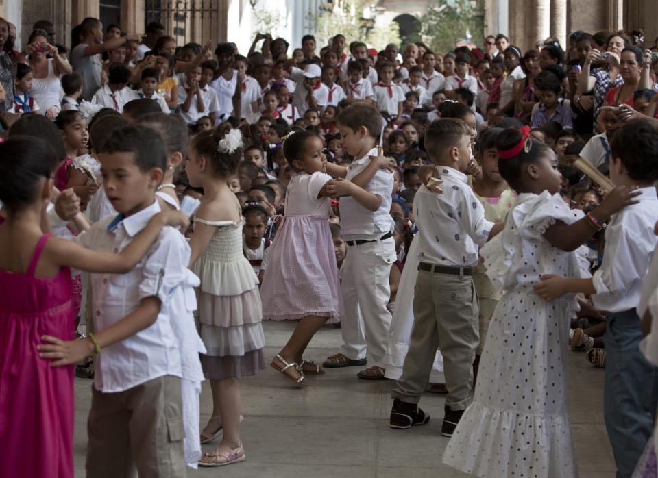 Young students perform during a celebration to mark the anniversaries of the Organization of Cuban Pioneers and of the Union of Communist Youth at the Angela Landa elementary school in Old Havana, Cuba, Friday, April 4, 2014. Cuban schoolchildren are referred to as "pioneers," and the organization was founded in 1961 to encourage the values of education and social responsibility among children and adolescents. (AP Photo/Franklin Reyes)