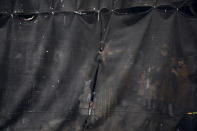 Ultra-Orthodox Jewish women are seen behind a curtain during the "Pidyon Haben" ceremony for Yossef Tabersky, a 30-day-old great grandchild of the chief rabbi of the Lelov Hassidic dynasty, in Beit Shemesh, Israel, Thursday, Sept. 16, 2021. The Pidyon Haben, or redemption of the firstborn son, is a Jewish ceremony hearkening back to the biblical exodus from Egypt. (AP Photo/Oded Balilty)