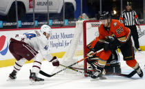 Anaheim Ducks defenseman Kevin Shattenkirk, front right, blocks a wraparound shot by Colorado Avalanche left wing Kiefer Sherwood, left, as Anaheim goaltender Ryan Miller protects the net during the first period of an NHL hockey game Saturday, March 6, 2021, in Denver. (AP Photo/David Zalubowski)