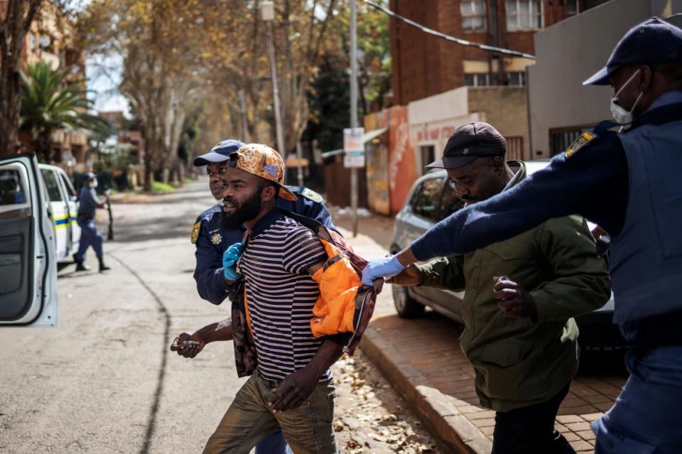 <div class="inline-image__caption"><p>"Members of the South African Police Service (SAPS) detain a man during a patrol in Yeoville, Johannesburg, on March 28, 2020, while trying to enforce a national lockdown amid concern of the spread of COVID-19 coronavirus."</p></div> <div class="inline-image__credit">Michele Spatari/AFP/Getty</div>