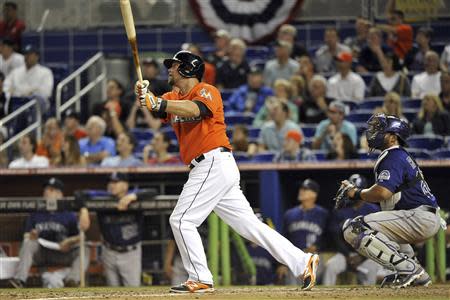 Mar 31, 2014; Miami, FL, USA; Miami Marlins third baseman Casey McGehee (9) connects for an RBI double in the eighth inning of an opening day baseball game against the Colorado Rockies at Marlins Ballpark. Steve Mitchell-USA TODAY Sports