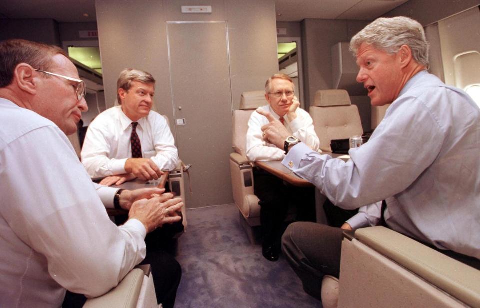 Bill Clinton meets with staff on Air Force One.