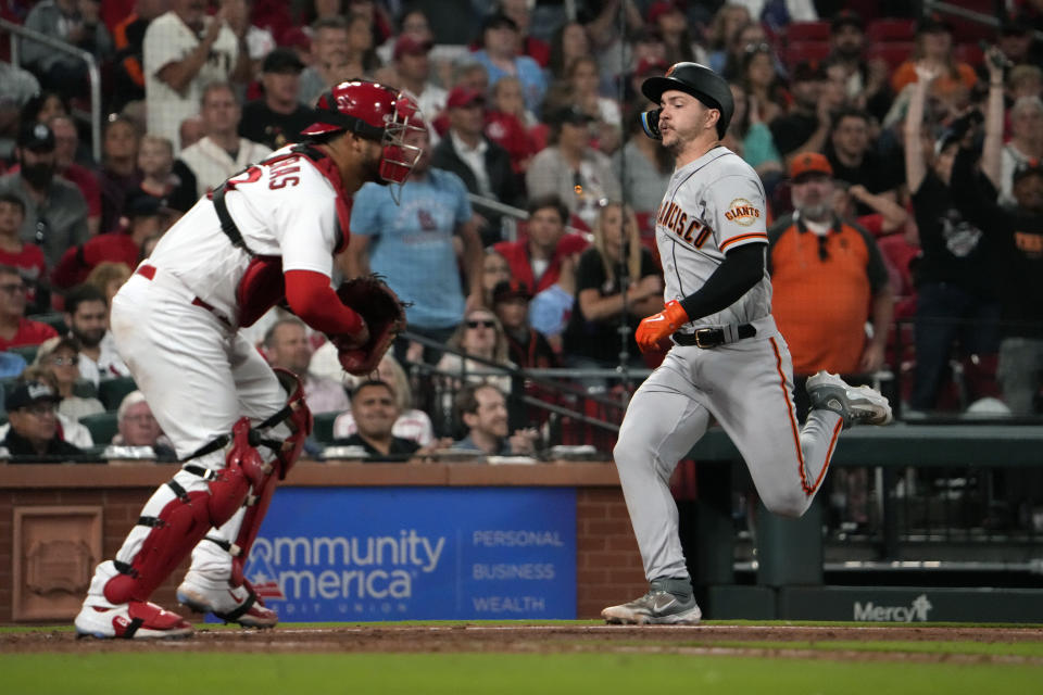 San Francisco Giants' Patrick Bailey, right, scores past St. Louis Cardinals catcher Willson Contreras during the eighth inning of a baseball game Monday, June 12, 2023, in St. Louis. (AP Photo/Jeff Roberson)