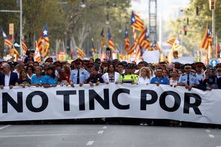 Representatives of rescue workers, police, health workers and citizens hold banner reading "We are not afraid" during a march of unity after last week attacks, in Barcelona, Spain, August 26, 2017. REUTERS/Juan Medina