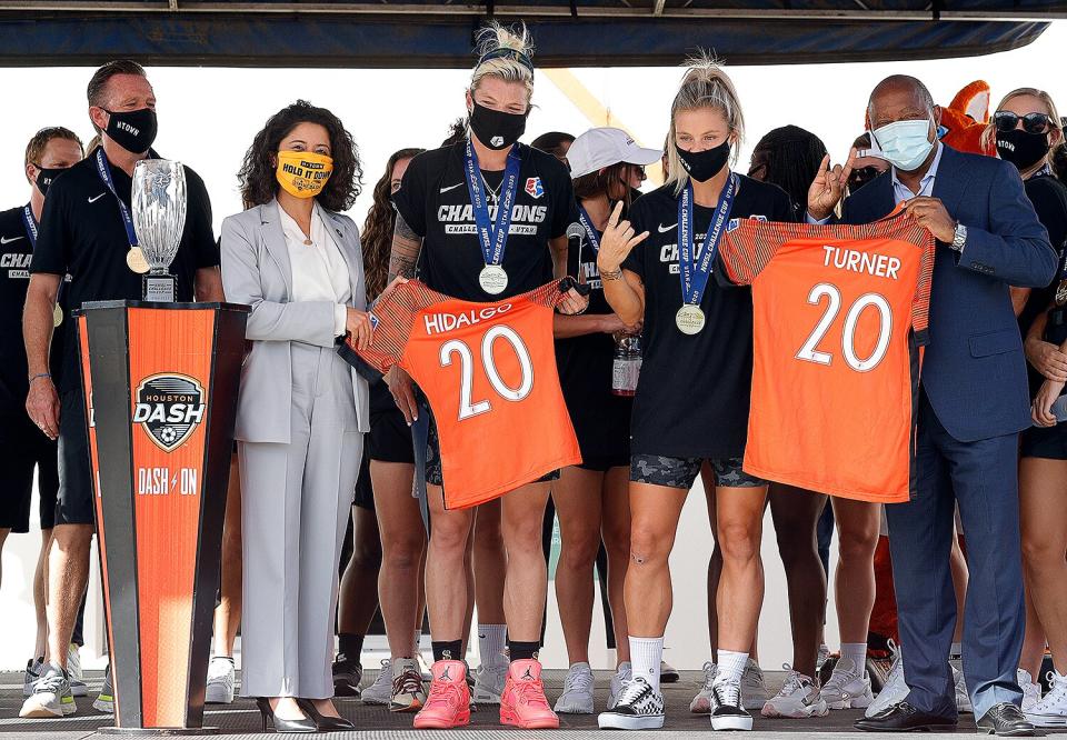 Members of the Houston Dash along with Harris County Judge Lina Hidalgo and Houston Mayor Sylvester Turner celebrate during a victory drive-through celebration on July 30, 2020