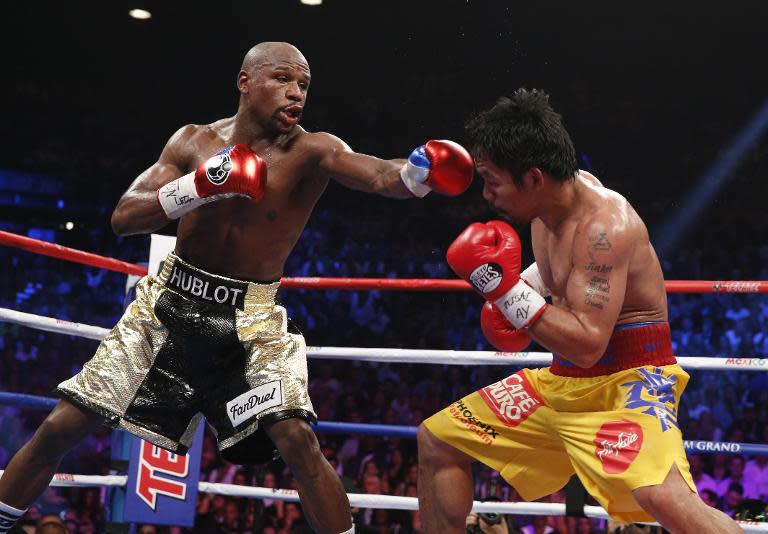 Floyd Mayweather Jr. (left) and Manny Pacquiao trade blows during their welterweight unification bout