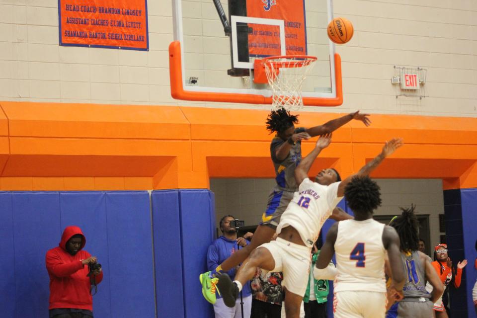 Beach's Shamarrie Hugie defends in the post against Malachi Robinson of Johnson (No. 12) on Friday night.