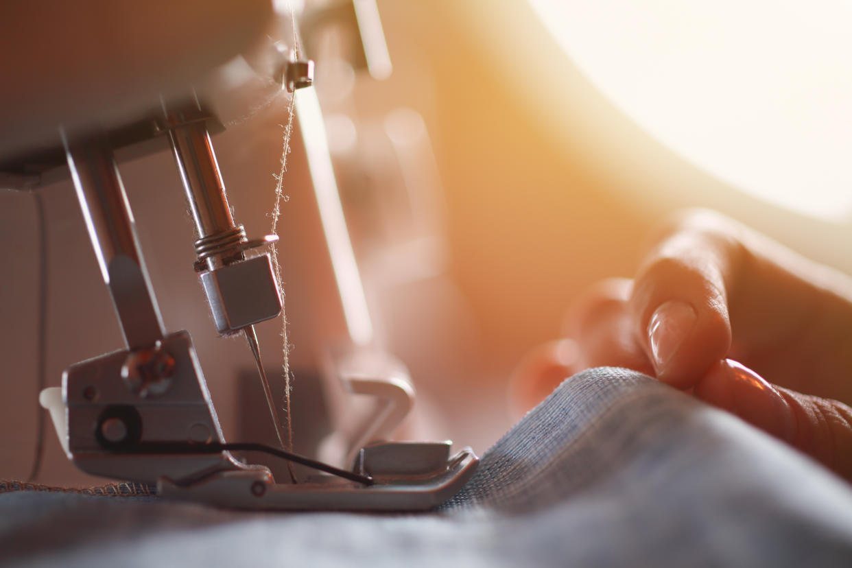 Tailor at Work on Sewing Machine.