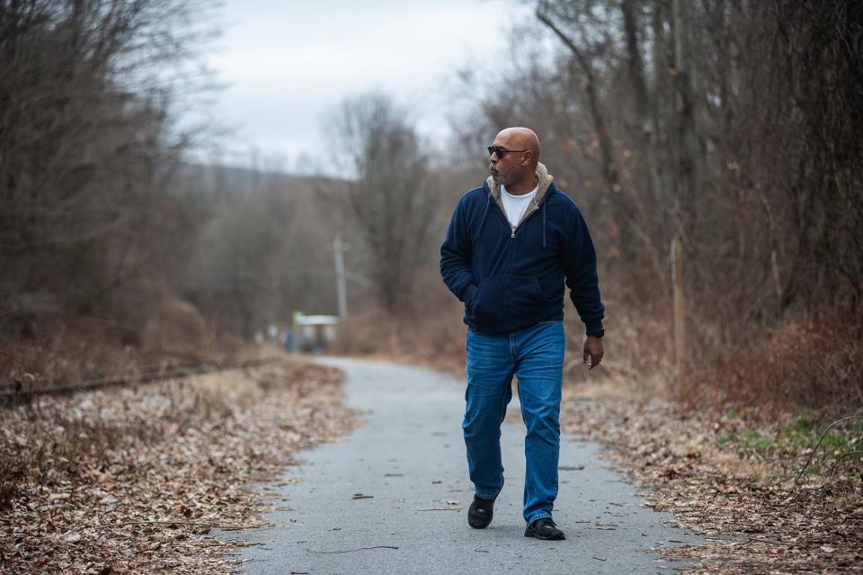 Ian Mandrew Prendergast of Poughquag stands for a portrait on a portion of a rail trail that borders his property in Poughquag, NY on Saturday, March 9, 2024.