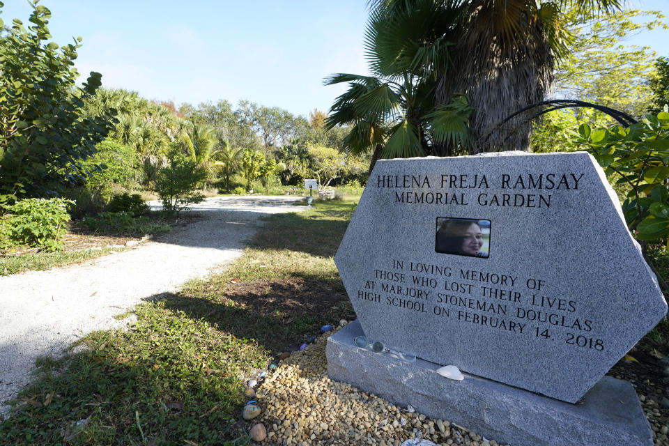 A garden dedicated to Helena Ramsay, one of the victims of Parkland's Marjory Stoneman Douglas High School shooting five years ago is seen Monday, Jan. 30, 2023, in Coral Springs, Fla. Ramsay's family built the community garden in her honor at a park a few miles from Stoneman Douglas. Visitors are greeted by a monument featuring a smiling portrait of the 17-year-old girl, who had come to the U.S. years earlier from Great Britain, and a dedication to those who died in the shooting. (AP Photo/Wilfredo Lee)