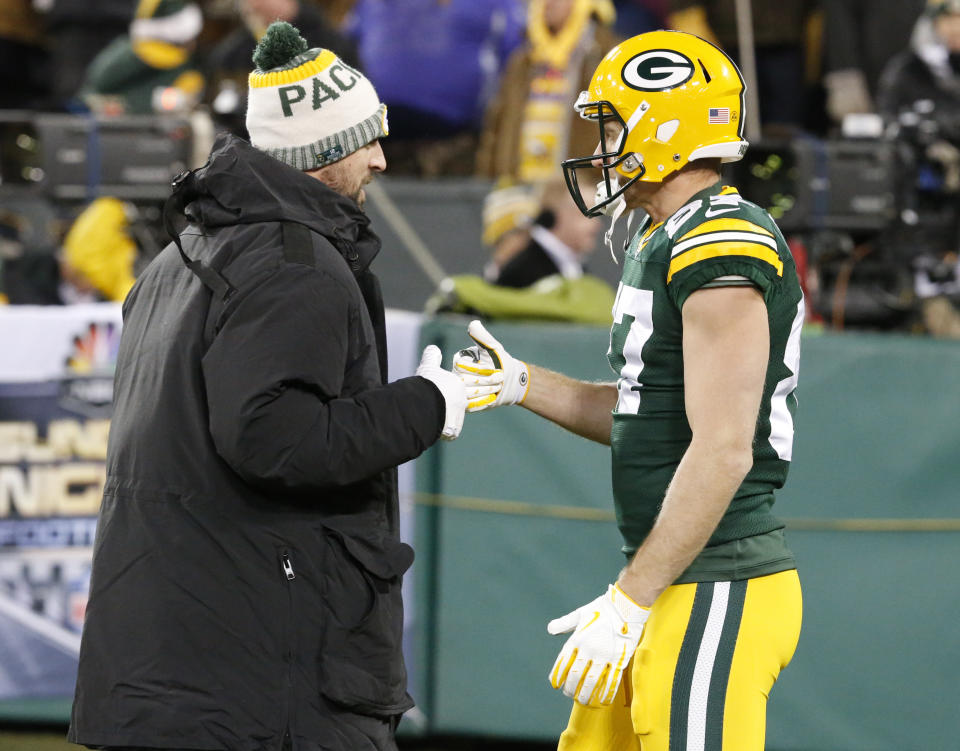 Green Bay Packers’ Aaron Rodgers shakes hands with Jordy Nelson before an NFL football game against the Minnesota Vikings Saturday, Dec. 23, 2017, in Green Bay, Wis. (AP Photo/Mike Roemer)