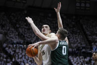 Purdue center Zach Edey (15) is fouled by Michigan State forward Jaxon Kohler (0) as he shoots during the second half of an NCAA college basketball game in West Lafayette, Ind., Sunday, Jan. 29, 2023. Purdue defeated Michigan State 77-61. (AP Photo/Michael Conroy)