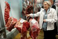 French presidential candidate for the far-right Front National party, Marine Le Pen visits the meat pavilion at the Rungis international food market near Paris, on April 25, 2017