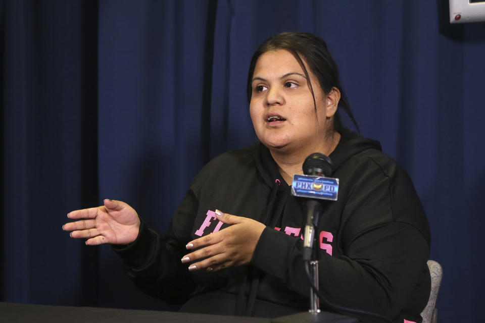 Shannon Vivar, 27, who was hit by a red light runner speaks at Phoenix Police headquarters about her ordeal Thursday, Oct. 24, 2019, in Phoenix. Authorities say Ernesto Otanez Oveso is accused of running a red light Oct. 14 in a hit-and-run car crash that nearly struck a couple pushing a stroller across a busy Phoenix street, and remains jailed on suspicion of leaving the scene of a collision and aggravated assault along with a weapons violation, a felony warrant in a probation violation and three misdemeanor warrants. (AP Photo/Ross D. Franklin)