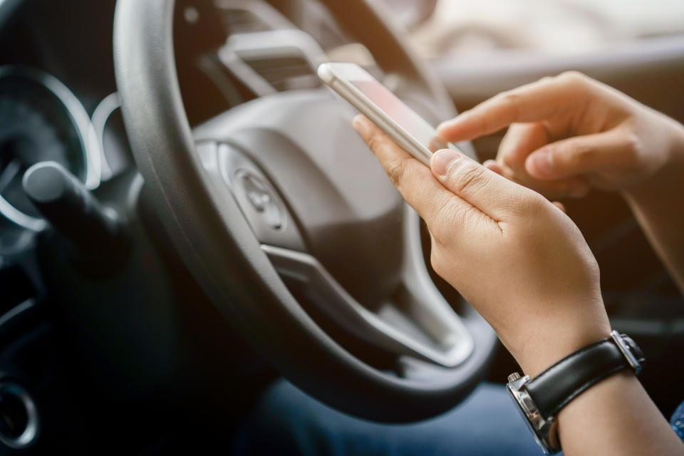 The expert recommends sharing your location with friends before meeting an online date. (Getty) close up driver woman hand holding smartphone for using GPS navigation of travel destination and swipe for reading data on web browser or texting message online for contact while parking , journey lifestyle concept