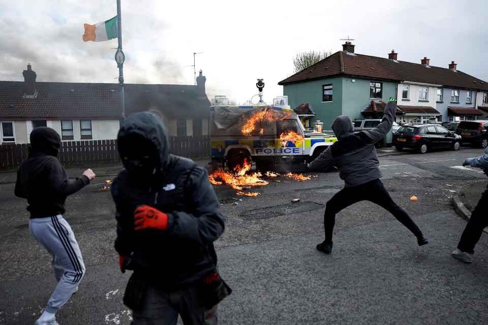 Dissident republicans throw petrol bombs at a police car after an anti–Good Friday Agreement rally, on the 25th anniversary of the peace deal, in Londonderry, Northern Ireland, on April 10, 2023. 