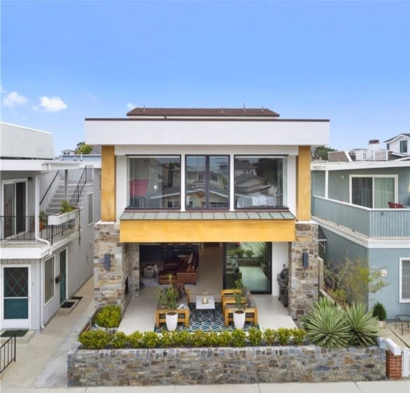The three-story home enjoys the coastal setting with a covered patio, balcony and rooftop deck. <span class="copyright">(Realtor.com)</span>