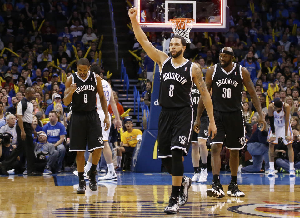 Brooklyn Nets guard Alan Anderson (6), guard Deron Williams (8) and forward Reggie Evans (30) celebrate as they walk off the court at the end of the third quarter of an NBA basketball game against the Oklahoma City Thunder in Oklahoma City, Thursday, Jan. 2, 2014. Oklahoma City won 95-93. (AP Photo/Sue Ogrocki)