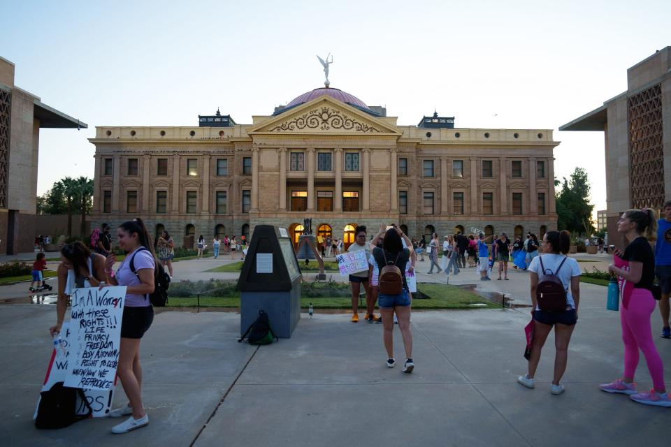 Protesters stand outside the Capitol in Phoenix after the "Bans Off Our Bodies" rally on May 14, 2022.