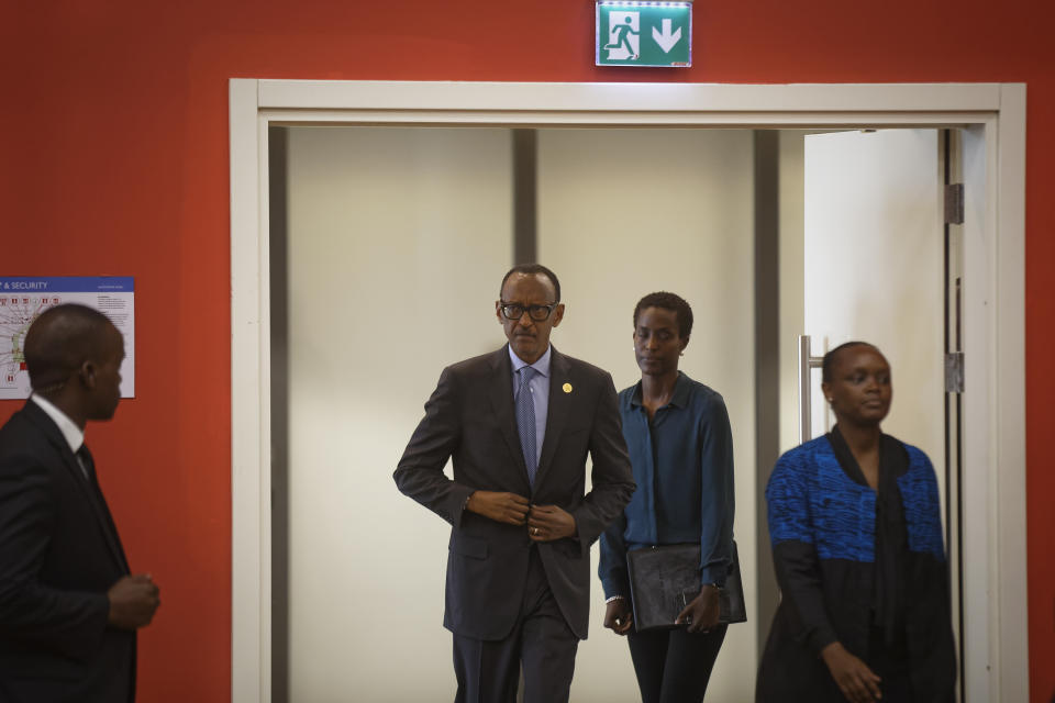 FILE - In this Monday, April 8, 2019 file photo, Rwanda's President Paul Kagame, center, arrives for a press conference at a convention center in the capital Kigali, Rwanda. A report commissioned by the Rwandan government due to be made public on Monday, April 19, 2021 concludes that the French government bears "significant" responsibility for "enabling a foreseeable genocide" that left more than 800,000 dead in 1994 and that that France "did nothing to stop" the massacres. (AP Photo/Ben Curtis, File)