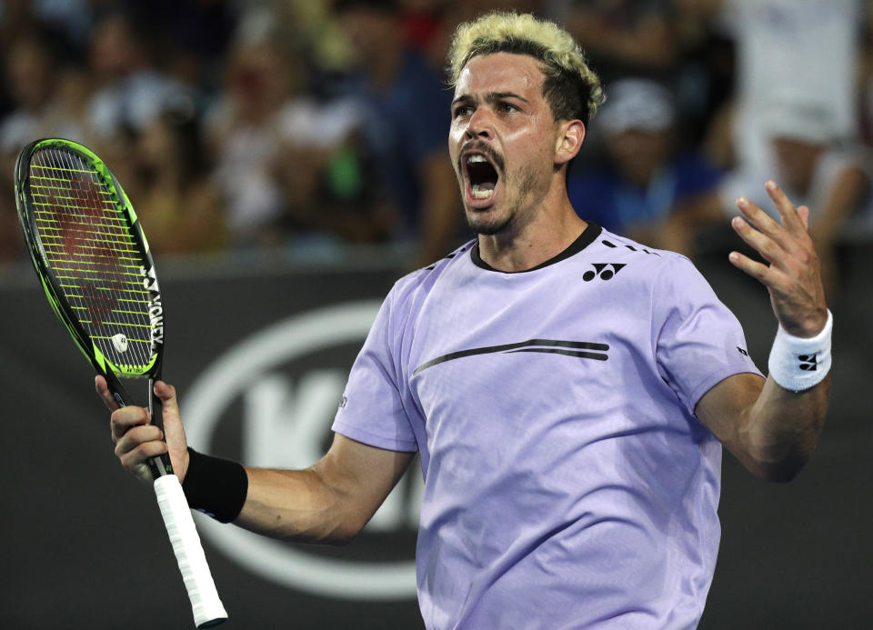 Australia's Alex Bolt celebrates a point win against France's Gilles Simon during their second round match at the Australian Open tennis championships in Melbourne, Australia, Thursday, Jan. 17, 2019. (AP Photo/Kin Cheung)