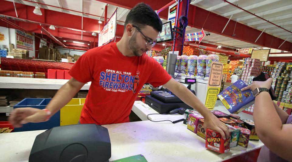 Cashier Ariel Colon checks out a customer at Shelton Fireworks in Blacksburg, South Carolina, Saturday morning, June 18, 2022.