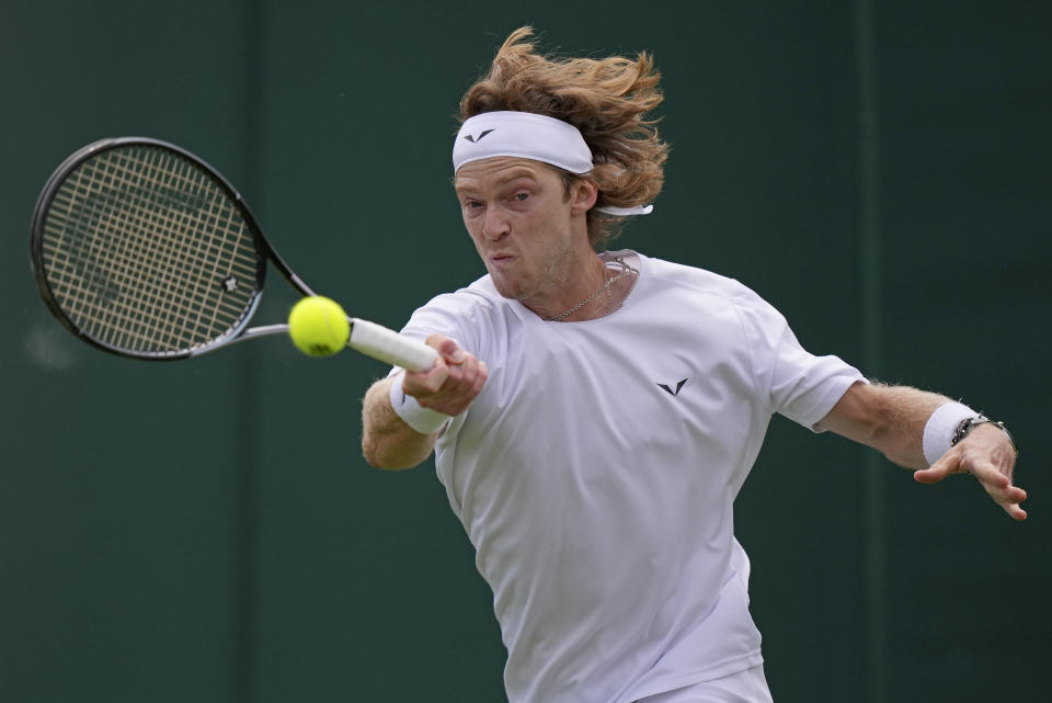 Russia's Andrey Rublev returns to Australia's Max Purcell during their first round men's singles match on day one of the Wimbledon tennis championships in London, Monday, July 3, 2023. (AP Photo/Alberto Pezzali)