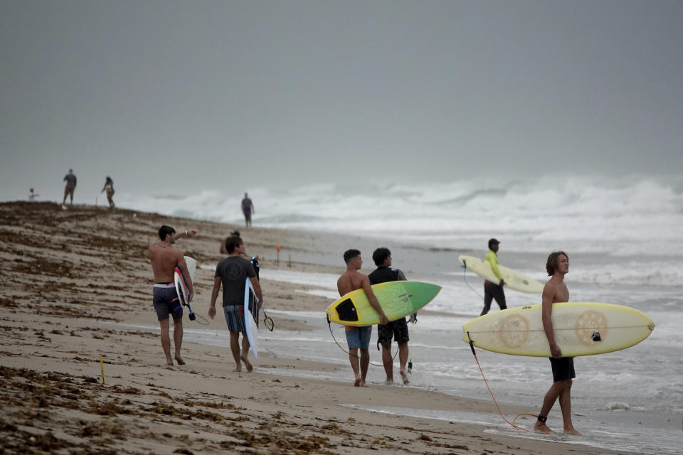 Surfers in Delray Beach enjoy the waves, Sunday, Aug. 2, 2020, as Tropical Storm Isaias brushes past the East Coast of Florida. (Joe Cavaretta/South Florida Sun-Sentinel via AP)