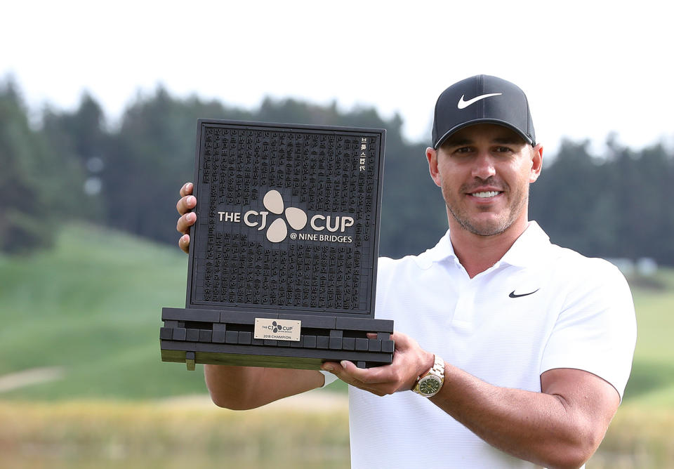 Brooks Koepka of the United States poses with his trophy after winning the CJ Cup PGA golf tournament at Nine Bridges on Jeju Island, South Korea, Sunday, Oct. 21, 2018. (Park Ji-ho/Yonhap via AP)