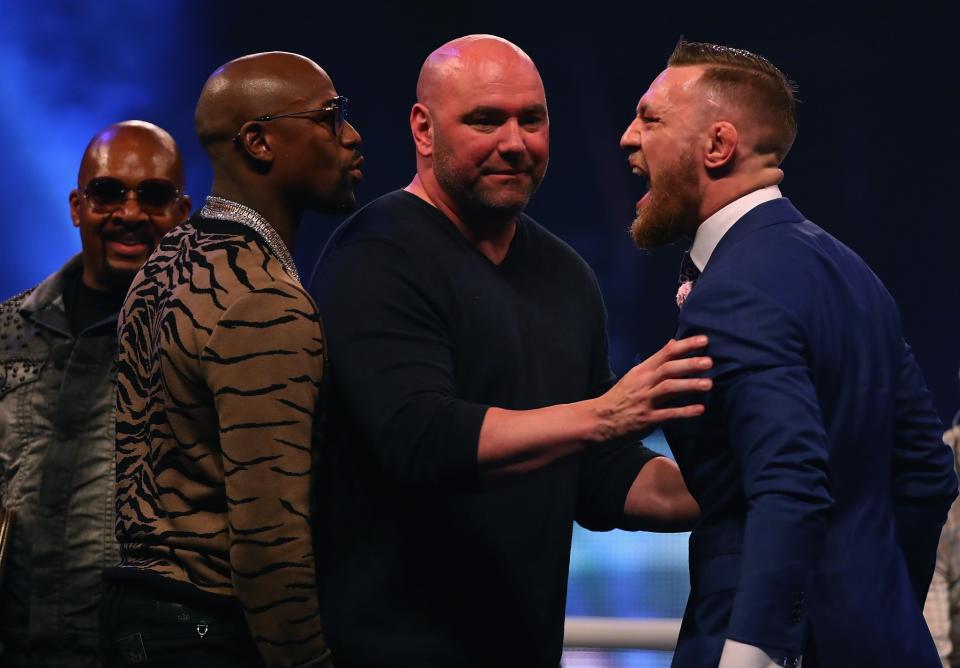 Floyd Mayweather (L) and Conor McGregor yell at one another during their Friday news conference. (Getty)