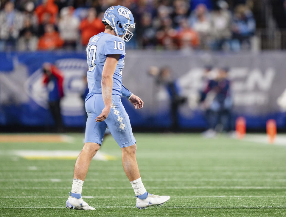 North Carolina quarterback Drake Maye walks off the field after an interception by Clemson in the second half during the Atlantic Coast Conference championship NCAA college football game on Saturday, Dec. 3, 2022, in Charlotte, N.C. (AP Photo/Jacob Kupferman)