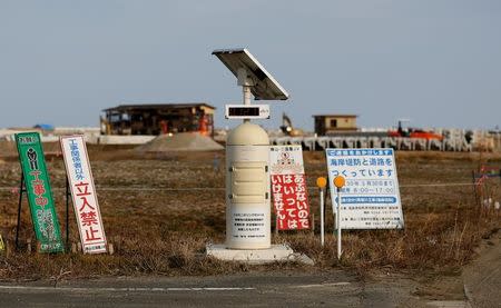 A Geiger counter, measuring a radiation level of 0.127 microsievert per hour, is seen at an area damaged by the March 11, 2011 tsunami, near Tokyo Electric Power Co's (TEPCO) tsunami-crippled Fukushima Daiichi nuclear power plant, in Namie town, Fukushima prefecture, Japan, March 1, 2017. REUTERS/Toru Hanai/Files