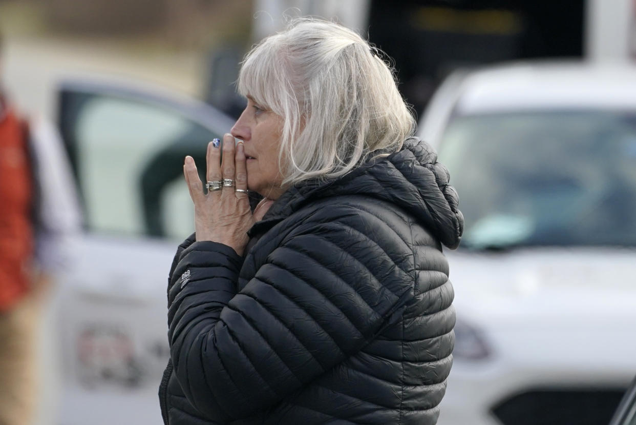 A woman reacts at the scene of a multiple shooting, Tuesday, April 18, 2023, in Bowdoin, Maine. (AP Photo/Robert F. Bukaty)