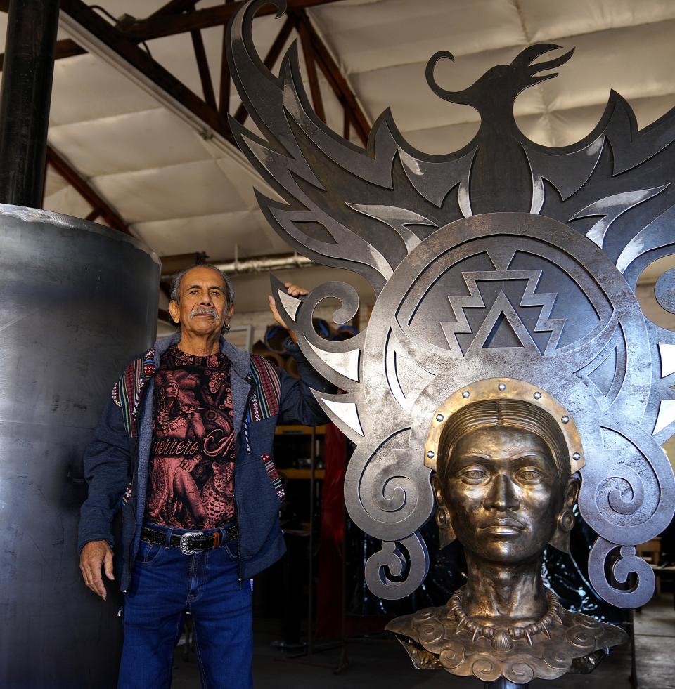 Zarco Guerrero stands with the bust of his sculpture in progress to be set at the light rail at the Baseline Road station on Jan. 11, 2022, in Mesa.