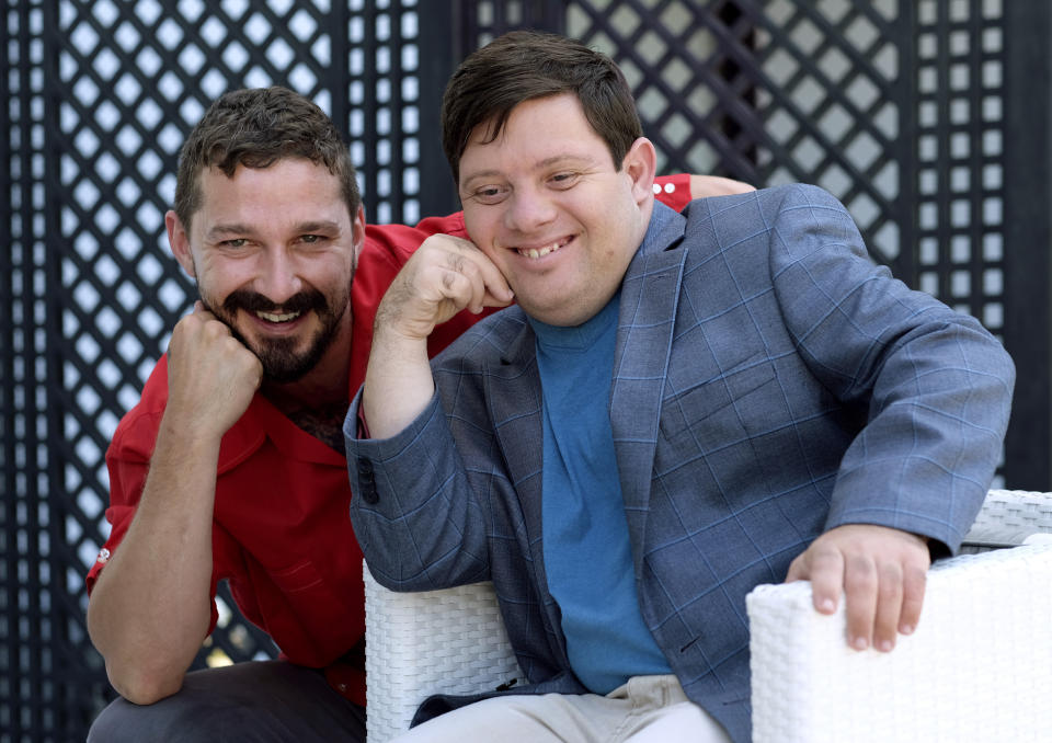 In this Friday, Aug. 2, 2019 photo, Shia LaBeouf, left, and Zack Gottsagen, cast members in the film "The Peanut Butter Falcon," pose together for a portrait at the London West Hollywood, in West Hollywood, Calif. The movie opens in the U.S. on Aug. 9. (Photo by Chris Pizzello/Invision/AP)