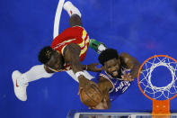 Atlanta Hawks' Clint Capela, left, blocks a shot by Philadelphia 76ers' Joel Embiid during the first half of an NBA basketball game, Saturday, Oct. 30, 2021, in Philadelphia. (AP Photo/Matt Slocum)