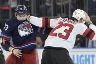 New Jersey Devils defenseman Kurtis MacDermid (23) fights New York Rangers center Matt Rempe (73) during the first period of an NHL hockey game, Wednesday, April 3, 2024, at Madison Square Garden in New York. (AP Photo/Mary Altaffer)