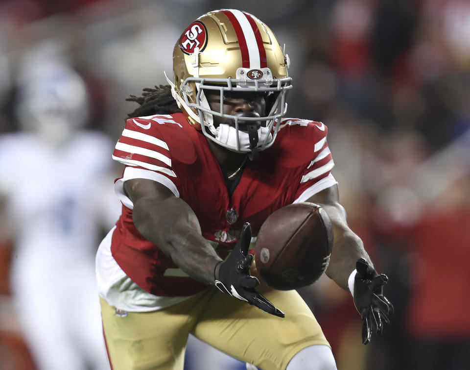 San Francisco 49ers wide receiver Brandon Aiyuk catches a pass against the Detroit Lions during the second half of the NFC Championship NFL football game in Santa Clara, Calif., Jan. 28, 2024. Aiyuk is staying away from the 49ers facility at the start of the offseason program as he seeks a lucrative long-term contract. (AP Photo/Jed Jacobsohn, File)