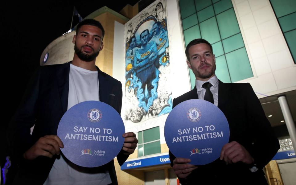 Ruben Loftus-Cheek (left) and Cezar Azpilicueta stand in front of the giant mural on the side of Stamford Bridge - Chelsea FC